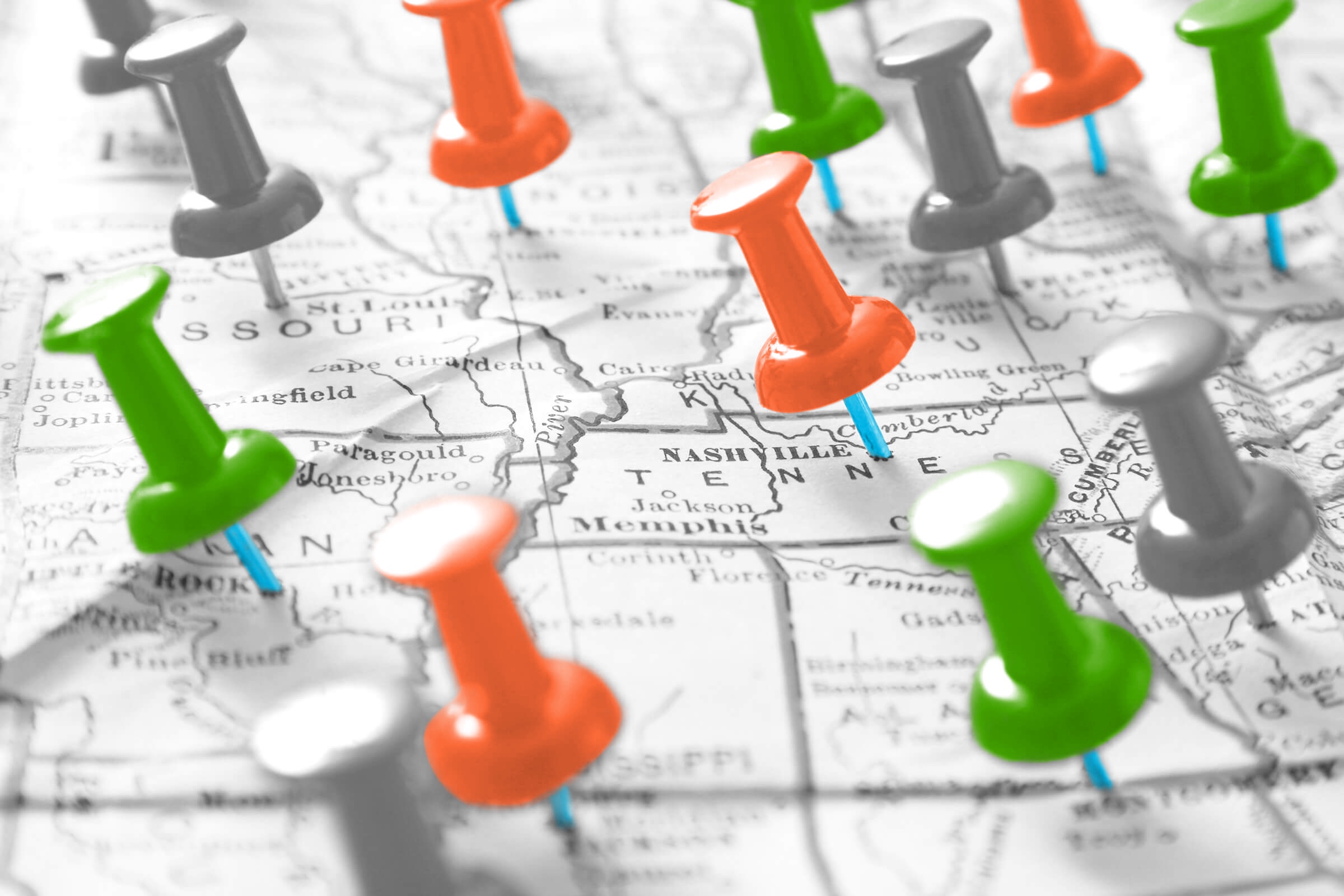 Close-up of a map covered in thumbtacks