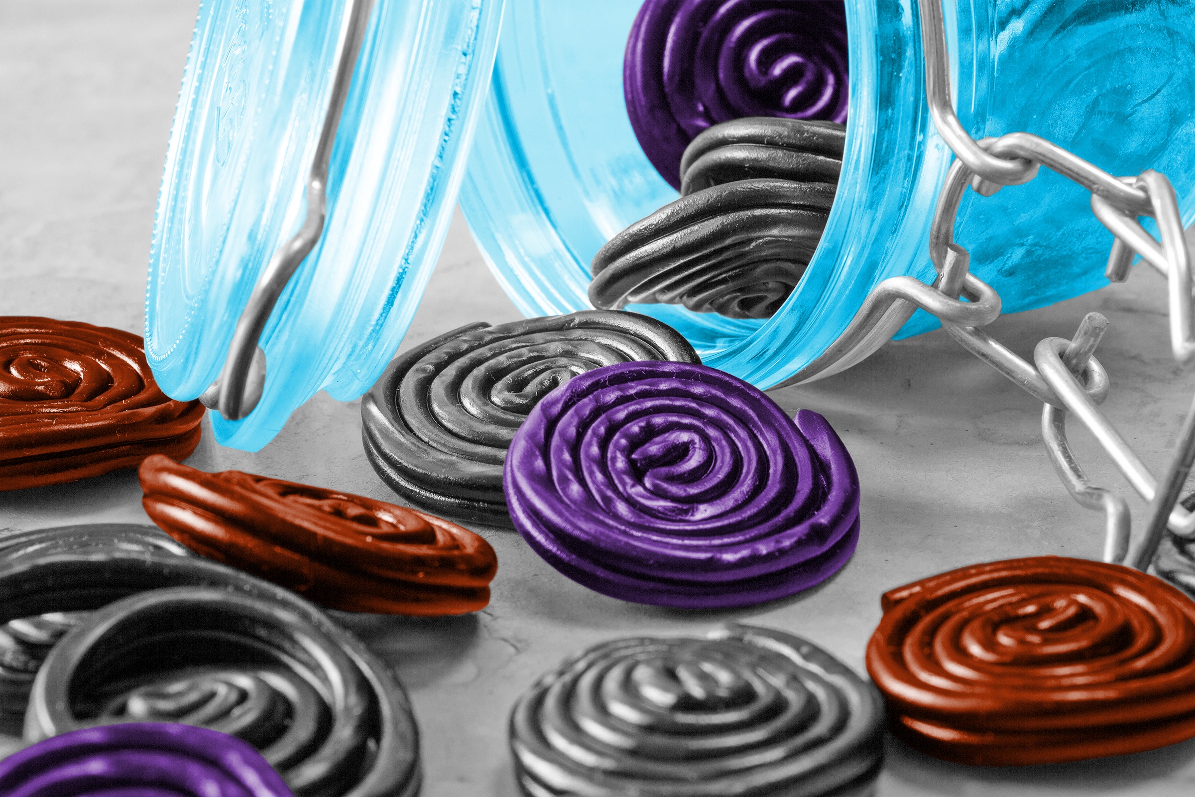 Spirals of licorice tumbling out of a jar