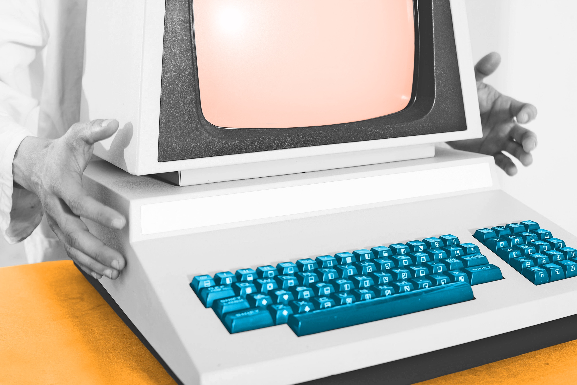 Person placing their hands on either side of a vintage computer