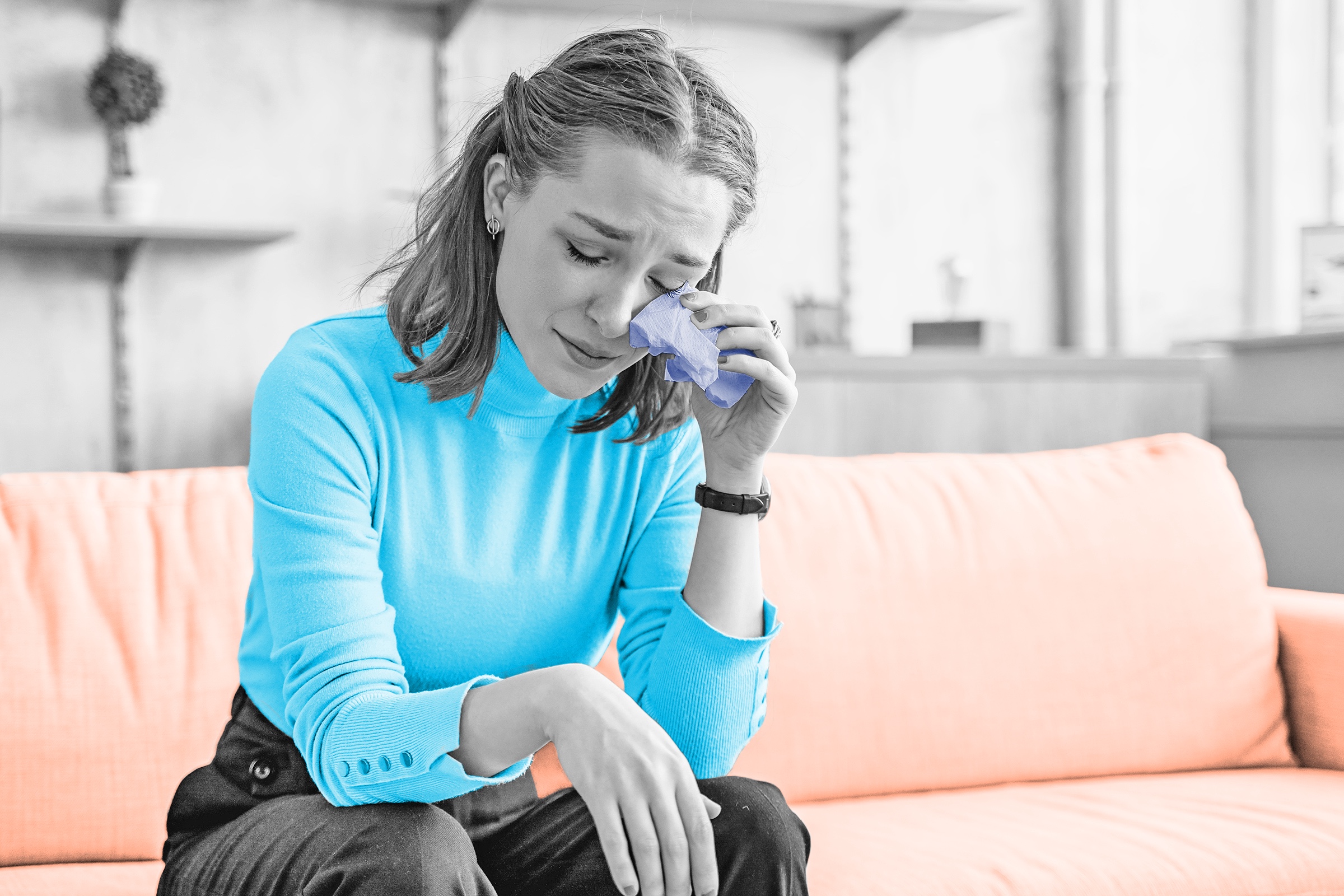 Woman wiping tears with a tissue