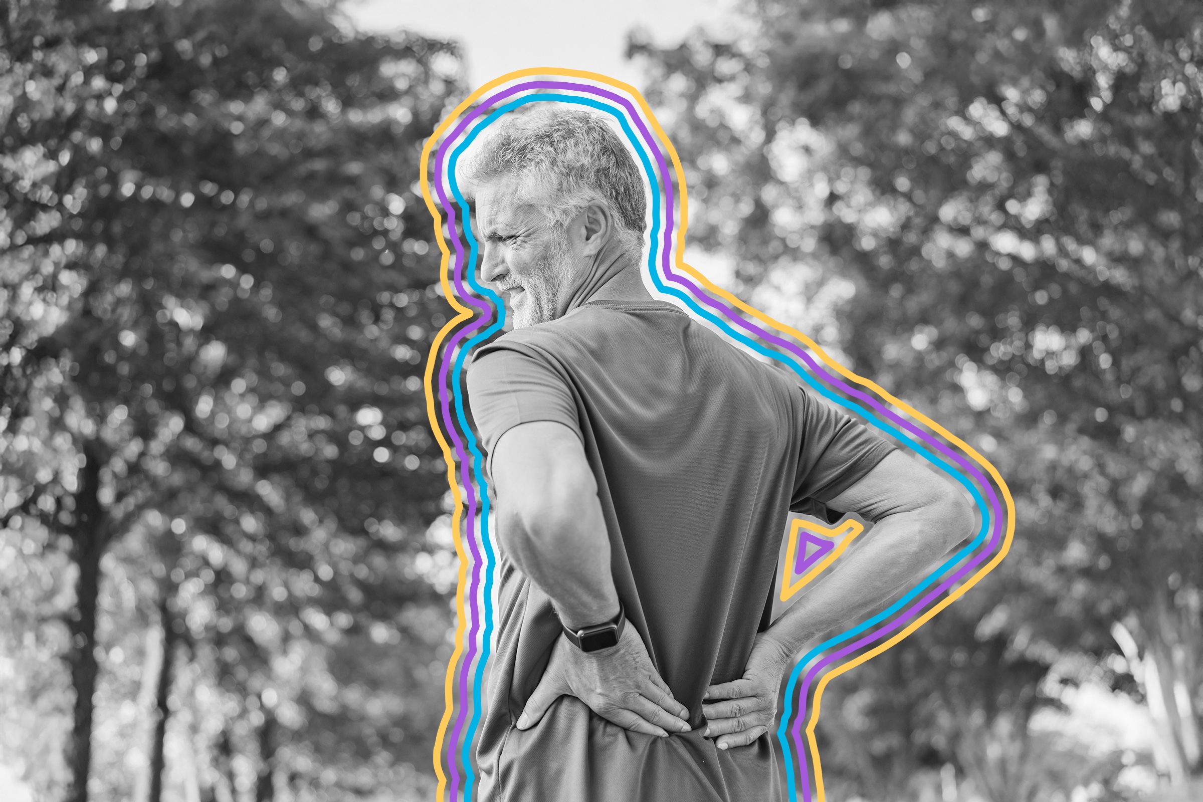 Older man wincing with his hands on his lower back