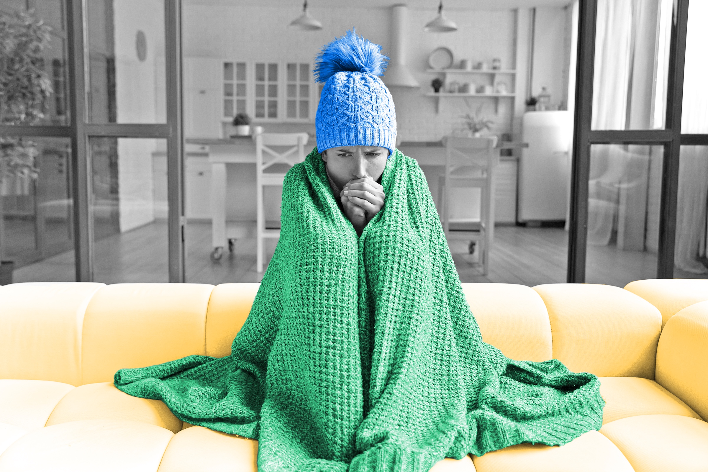Person bundled up in blanket and knit winter hat