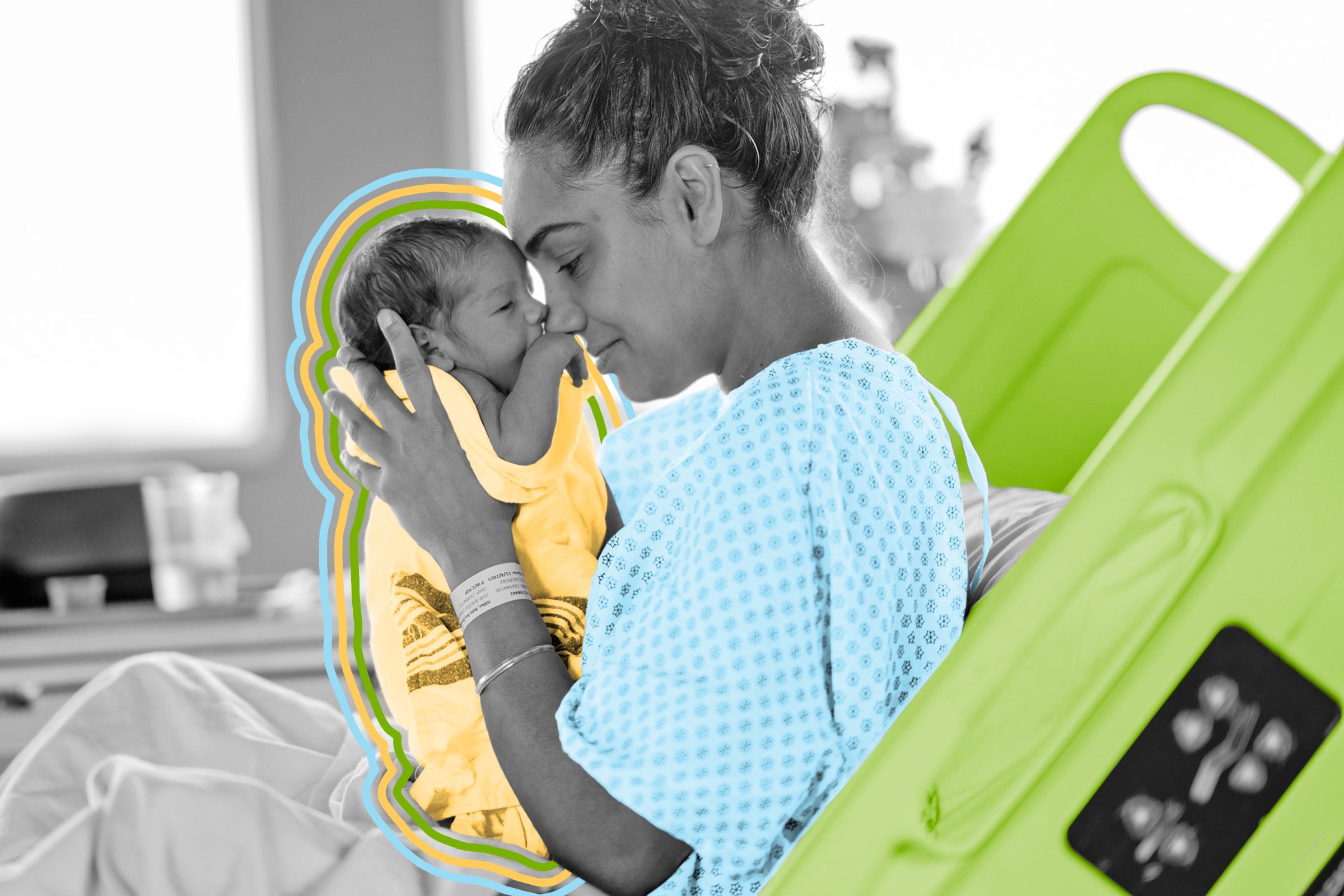 Woman in a hospital bed holding her newborn infant