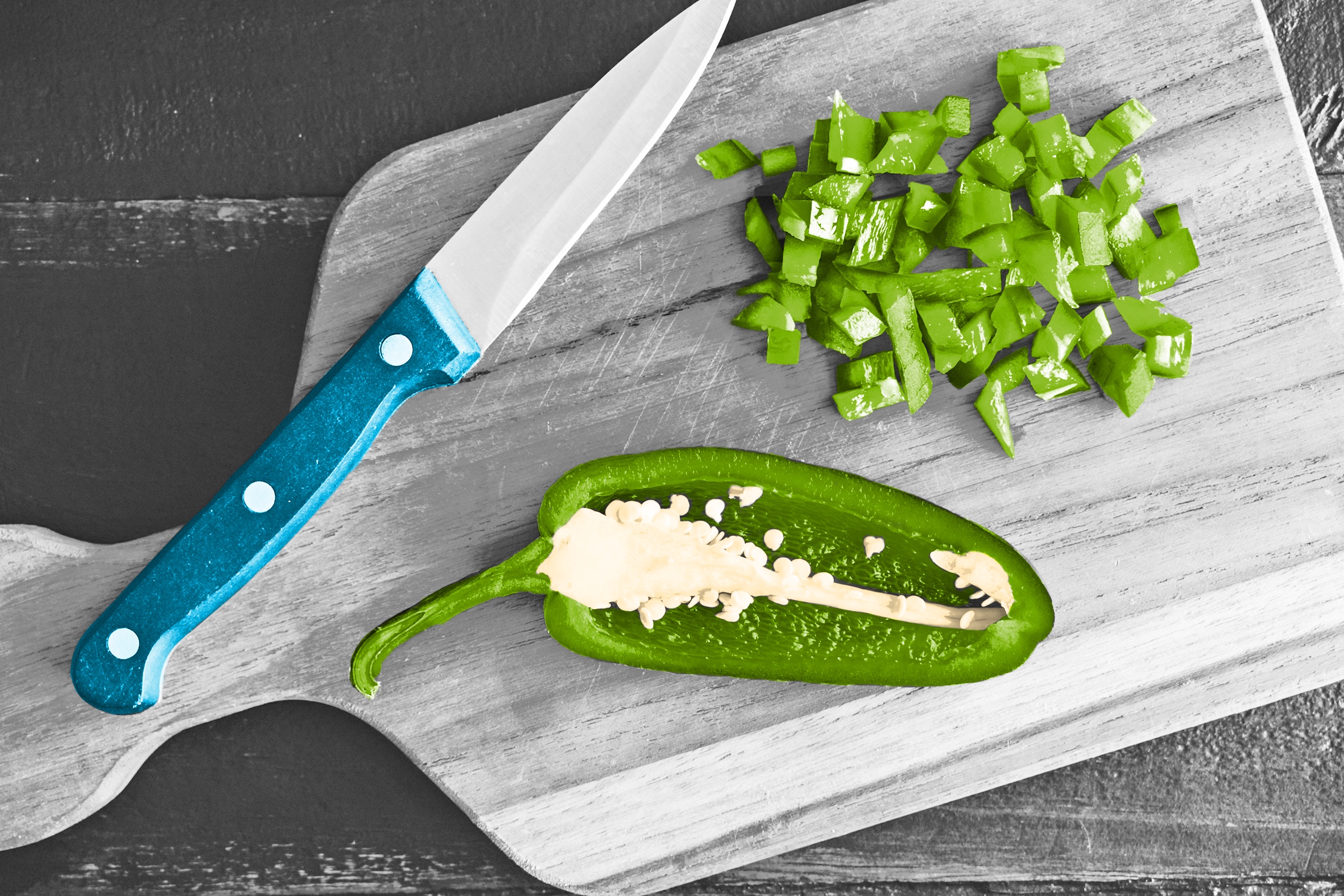 Jalapeño pepper diced on a cutting board