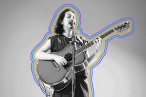 Person singing into a mic and playing guitar