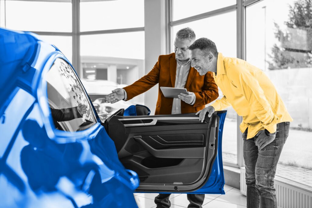 Two men looking at a car for sale
