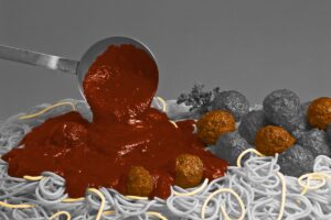 Ladle pouring sauce onto spaghetti and meatballs