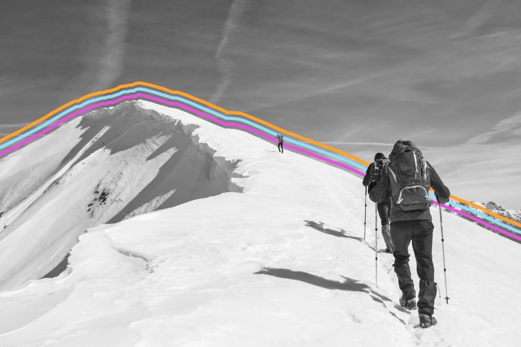 Hiker climbing the snowy peak of a mountain