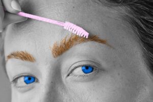 Woman grooming her eyebrows